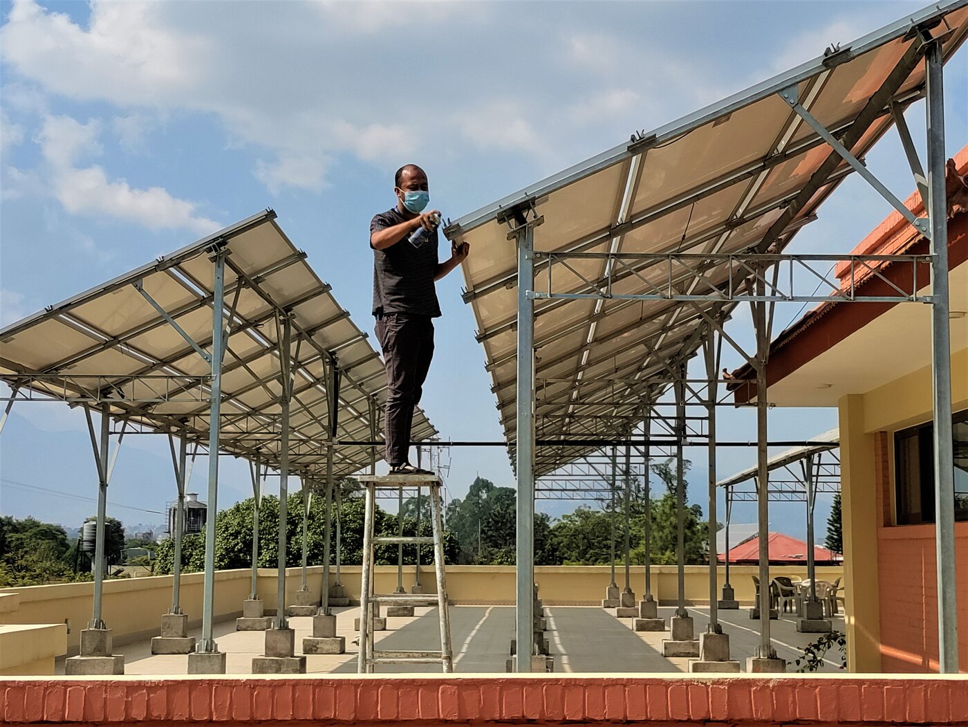 Installing solar panels on the rooftop canopy