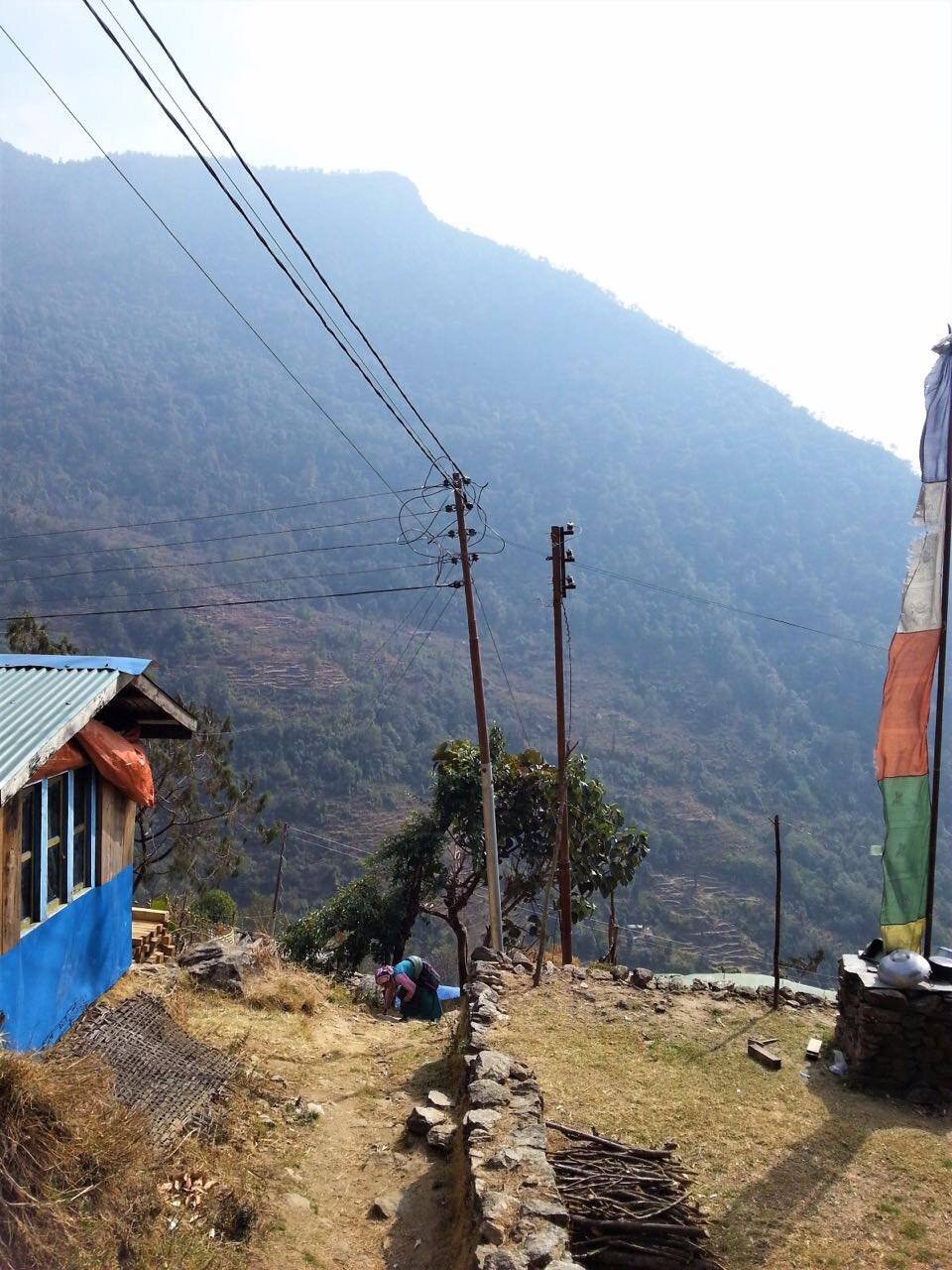 Porters carrying battery boxes up the mountain trail to Simigoan
