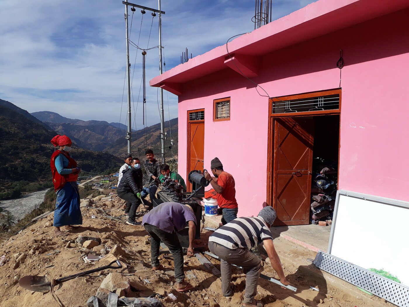 Erecting a transmission pole at Thawang